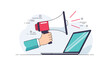 © Tithi - Hand holding a red megaphone and pointing it at an open laptop screen for digital marketing, advertising, and online announcements.