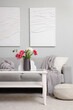 © Pixel-Shot - Interior of living room with sofa, table and tulips in vase for Women's Day