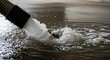 © Nataly - Water removal process with hose extracting fluid from flooded area, showcasing splashes and motion in stagnant water. Effective water removal aids in restoring spaces after heavy rainfall or flooding.