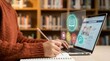 © MAJHI LAB - Person wearing orange sweater using laptop with online learning in library education technology