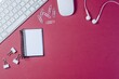 © dandy - Red and white paper clips, a phone, and an arrow lie on a black desk next to a laptop and office equipment for business communication