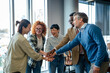 © Miljan Živković - Diverse business team stacking hands showing unity and collaboration