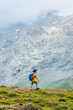 © zhukovvvlad - Traveling child. a tourist with a backpack walks along a mountain road. hiking and active healthy lifestyle.