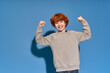 © Bliss - Stylish little boy confidently poses against a bright blue background, showcasing his unique charm