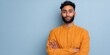 © Andrii Zastrozhnov - Confident male asian young adult portrait with folded arms wearing mustard kurta against pale blue wall