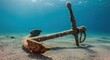 © Bejo Studio - Rusty Anchor Submerged Underwater on Sandy Seabed in Clear Blue Water.