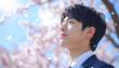 © Tori_ice - 決意をもった表情の男子高校生、桜の背景