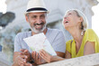 © auremar - happy mature couple looking for directions using a map