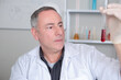 © auremar - portait of senior doctor holding blood tube
