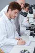 © auremar - scientists with clipboard and microscope in lab
