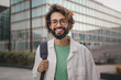 © EFStock - Portrait of young confident man with eyeglasses and beard smiling in the city