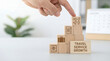 © RayenAI Studio - Hand strategically placing an airplane block on a stack of travel-themed wooden cubes, symbolizing the successful growth and development of travel services