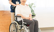 © buritora - A senior woman in a wheelchair and a female staff member working at a nursing home.