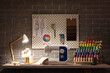 © Pixel-Shot - Interior of dark atelier with tailor's workplace, pegboard and glowing lamp