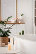 © Pixel-Shot - Interior of bathroom with bathtub, table and burning candles