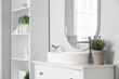 © Pixel-Shot - Pot with lavender flowers near sink in modern bathroom