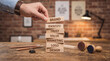 © Navee - Brand identity concept with wooden blocks showing marketing design elements on office desk