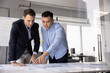 © fizkes - Focused analytical teamwork. Professional business team two multicultural specialists associates exchange ideas brainstorm insights collaborate at project table with statistic information. Copy space