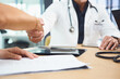 © peopleimages.com - Doctor, people and handshake in hospital with meeting, onboarding or recruitment for medical service. Healthcare worker, job candidate and shaking hands in clinic with hiring offer, welcome or intro.