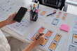 © Phimwilai - Designer creating mobile application user interface wireframes