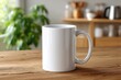 © Ievgeniia - White ceramic coffee mug on wooden table in cozy kitchen interior, side handle visible, soft daylight, blurred shelf with kettle and bowls, green houseplant