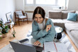 © Graphicroyalty - Professional Female Entrepreneur Working on Laptop and Taking Notes in Home Office. Focused Woman Managing Remote Business Workflow with Notebook and Computer in Bright Modern Workspace