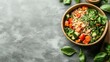 © Tetiana - Wooden bowl filled with fresh grains, chopped vegetables, and green leaves, presented on a textured surface for healthy eating.