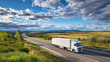 © Tiwakeat - Long haul cargo truck driving on open highway under blue sky with clouds, countryside landscape