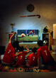 © master1305 - Family watching soccer match on TV at home and cheering for goal together. Concept of streaming service promotion, smart TV usage, home entertainment platform, and digital media consumption