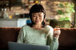 © Davor - Woman shopping online with credit card at home