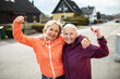 © Marko Geber - Two senior women celebrating fitness on suburban street