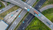 © Fahroni - Aerial view of modern highway interchange with autonomous vehicles and connectivity symbols. Smart traffic systems and 5G technology for future transportation and intelligent mobility solutions.