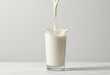 © Aura84 - Milk pouring into glass with splash on clean white background