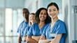 © Mary - Smiling healthcare team in blue scrubs stands in a hospital corridor, conveying professionalism and teamwork.