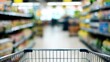 © The Little Hut - Grocery Shopping: An Empty Cart Navigating Aisles in a Supermarket Setting with Blurred Background