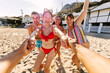 © Xavier Lorenzo - Diverse group of young friends joyfully running hand in hand along a sunny sandy beach, laughing and smiling during a carefree summer vacation by the sea, full of fun and energy
