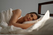 © MDTUFAN - Woman resting in bed a moment of peace and tranquility