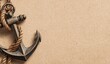 © Afsana - A rustic vintage metal anchor rests on a grainy tan surface with a thick natural fiber rope winding through its ring and around its weathered iron shank