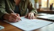 © miss irine - Person writes on paper document with pen. Updating resume for job advancement. New career role, employment progress and personal growth reflected.