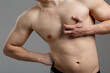 © skeronov - A young guy with an athletic build is experiencing painful sensations in the heart area. The concept of: heart disease, first aid, men's health