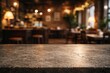 © vxnaghiyev - Vintage style stone table surface with blurred bokeh effect in a cozy cafe interior perfect for product showcasing