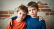 © Inspire Shots Hub - Two young boys pose closely, embracing each other in front of a brick wall, representing kinship, support, and familiar bond, great for family concepts