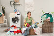 © Pixel-Shot - Young woman sorting dirty laundry near washing machine at home
