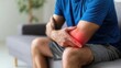 © Iaroslav - Man feeling elbow pain, experiencing joint inflammation and physical injury on home his arm