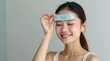© Petro - Young Woman Enjoying Skincare Routine While Using Facial Mask for Relaxation and Wellness