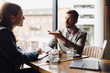 © Novak - Professional businessman explaining a project or concept to a female colleague