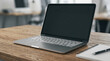 © Vera - Modern laptop on wooden desk with notebook and office background