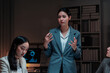 © Crystal - Asian businesswoman discussing plans with colleagues, working late in office, analyzing data on screen for strategic presentation