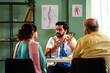 © StockImageFactory - Indian doctor discussing health results with retired Asian seniors in a professional office.