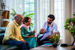 © StockImageFactory - Indian doctor explaining a medical file to a senior Asian couple sitting on a clinic sofa.